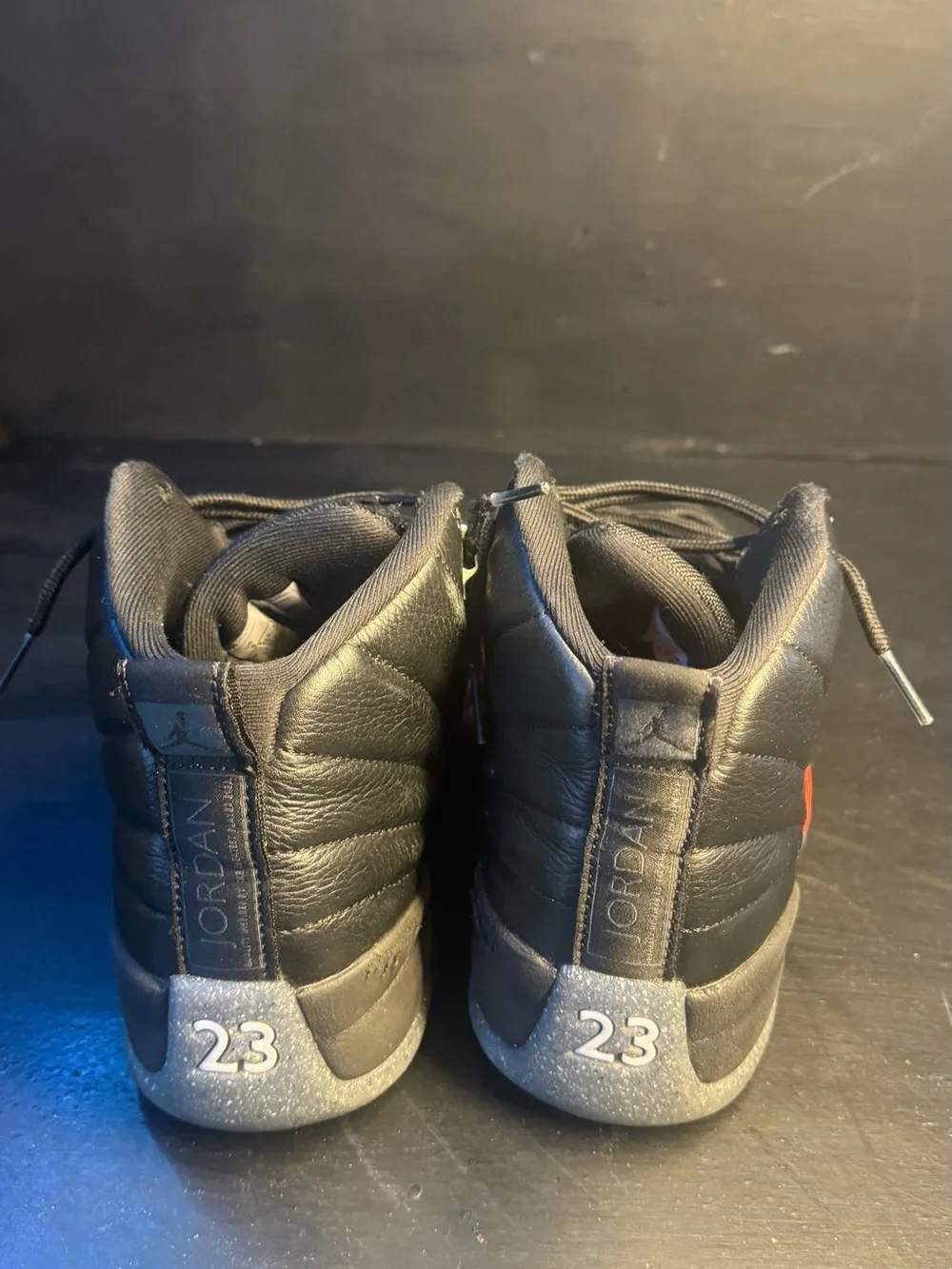 Men's Jordan 12 Black High-Top Athletic Sneakers with Subtle Orange Accent